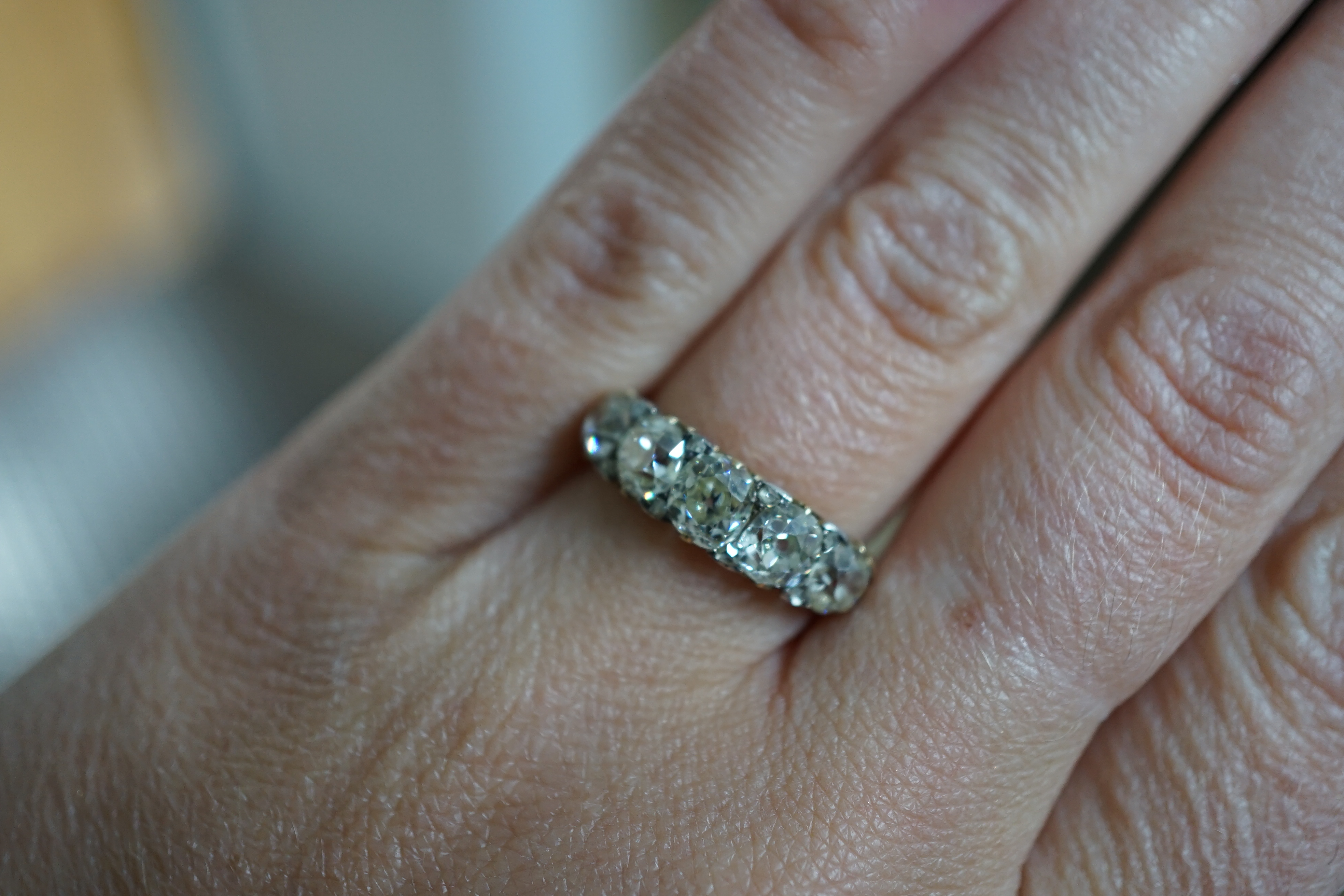 A Victorian 18ct and graduated five stone old round cut diamond set half hoop ring